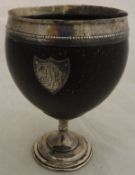A coconut goblet, the plain polished bowl with white metal rim,