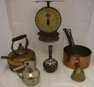 A set of three graduated copper saucepans with iron handles, a copper kettle,
