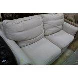 A modern cream upholstered two seat sofa (loose covers) and a similar fawn upholstered sofa,
