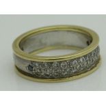 An 18 carat gold diamond and emerald ring