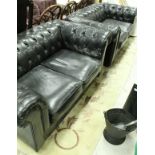 A pair of modern black leather Chesterfield two seat sofas