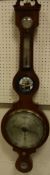 A mahogany barometer of banjo form and with satinwood banding, marked "J.T.