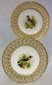 A pair of cabinet plates, each with painted decoration of birds "The Wheat Ear" and "The Goldfinch",