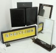 A Gucci brown leather pen collector's case, a Breitling advertising sign, a TAG Heuer mirror,