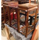 A pair of hardwood Chinese style occasional tables with latticed undertier together with a further