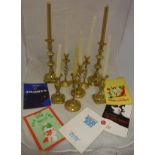 Two pairs of brass candlesticks and a set of four brass candlesticks with open double helix twist