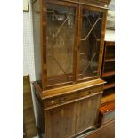 A modern yew wood bookcase cabinet,