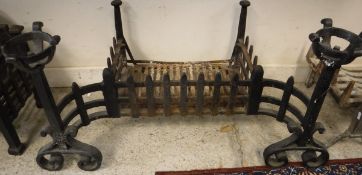 An iron fire basket with itegral andirons