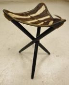 A folding stool with Zebra hide seat - taxidermy