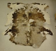 A worn Cow hide rug - taxidermy
