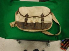 A canvas and leather trimmed fishing bag