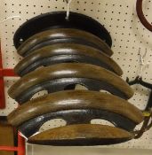 A wrought iron mahogany wall-mounted saddle rack