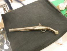 A Georgian muzzle loading flint lock pistol by Strange with brass mounts and embossed with emblems