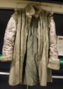 A grey mink lined full length coat CONDITION REPORTS The lining to the coat has