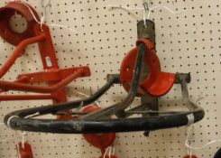A plastic coated wall-mounted saddle rack and a separate bridle rack