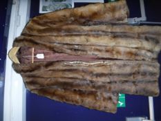 A brown Musquash three quarter length coat
