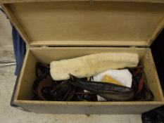 A tack box containing various head collars, riding crops one with silver ferule,