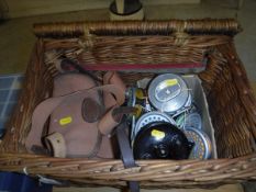 A wicker fisherman's basket containing eight fly fishing reels by Intrepid and Leeda,