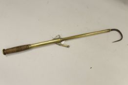 A brass two draw extending salmon gaff with rosewood handle