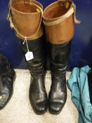 A pair of black leather huntsman's boots with mahogany tops,