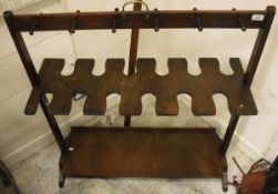 A mahogany whip and boot rack with brass carrying handle