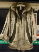 A silver mink and leather panelled coat of segemented form,