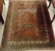 A Mahib design carpet, the central panel on red ground within a stepped red,