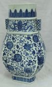 A Chinese blue and white foliate and flower head decorated flattened baluster shaped vase,