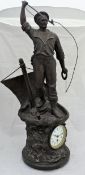 A clock housed in a large bronze patinated spelter sculpture of a cod fisherman