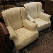 Two early 20th Century wingback chairs with scroll arms,