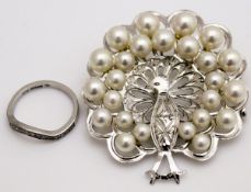 A platinum and diamond wedding band and a silver peacock brooch set with pearls (2)