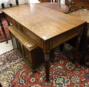 An oak writing table, the plain top above two drawers with panelled detail,