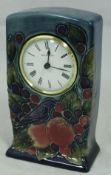 A Walter Moorcroft clock decorated with bird amongst peaches and cherries,