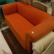 An early 20th Century orange upholstered drop-arm Chesterfield sofa