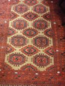 A Beluch rug, the central panel set with repeating medallions on a brown ground,