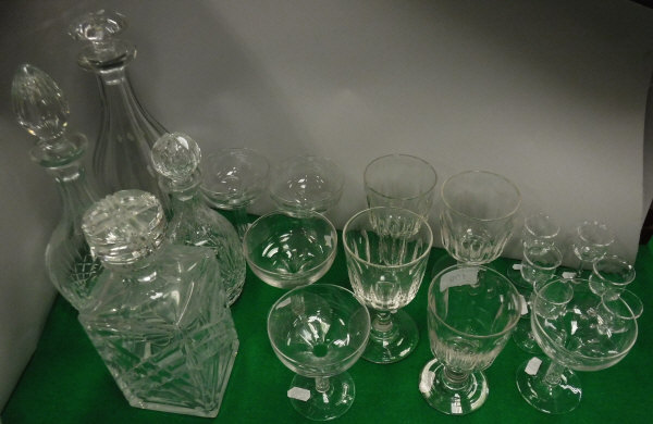 Four various decanters and stoppers, five champagne saucers with hollow stems,