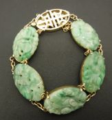 A Chinese 14 carat gold mounted jade bead bracelet with five oval carved stones CONDITION