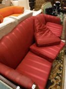 A Georgian style four seat sofa with red upholstery to carved cabriole legs