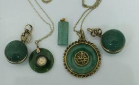 A Chinese yellow metal mounted jade Bi disc pendant with central characters,