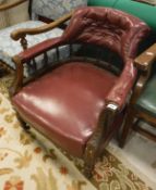 A Victorian walnut framed salon chair with red leather upholstery on turned and ringed supports to