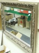 A rectangular mahogany framed wall mirror with carved ribbon decoration to the top,