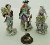 A pair of Sitzendorf figures of flower sellers with sheep,