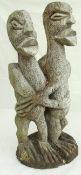 An ethnic carved wooden figure group of an embracing couple