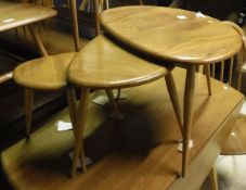 A nest of three Ercol pebble tables CONDITION REPORTS Condition basically sound
