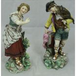 A pair of 19th Century Continental (possibly Volkstedt) figures of man with a monkey upon his