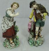 A pair of 19th Century Continental (possibly Volkstedt) figures of man with a monkey upon his