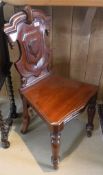 Two mahogany hall chairs with shield shaped backs