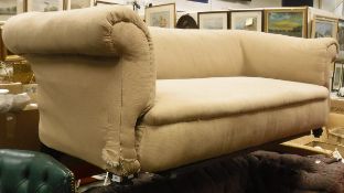 A mushroom coloured upholstered Chesterfield style sofa on turned and brass castered legs
