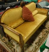 A mahogany framed gold upholstered settee, the back with a central carved disc depicting corn,