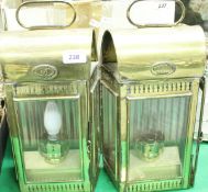 A pair of Christopher Wray wall lamps in the form of railway lamps